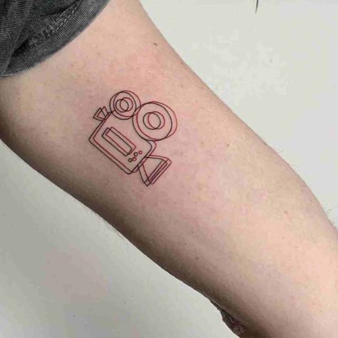 87 Camera Tattoo Ideas for Minimalist Photographers - TattooGlee Film Tattoos Ideas, Film Tatoos, Film Tattoos Minimalist, Minimalist Photography Tattoo, Cute Movie Tattoos, Projector Tattoo, Tattoos For Movie Lovers, Film Minimalist Tattoo, Tattoo Ideas Movies