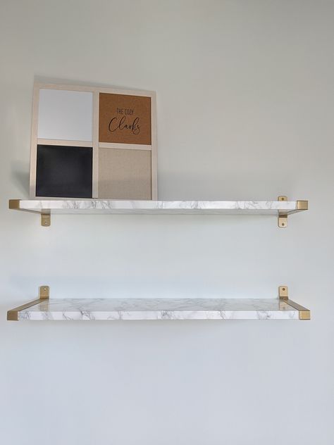 Click to see how I made these Ikea hack marble and gold floating shelves—and let me know whether you think it was a flip or a flop. Ikea Floating Shelves Hack, Marble Shelves Living Room, Marble Shelves Bathroom, Marble Floating Shelves, Glass Floating Shelves, White And Gold Shelves, White And Gold Shelves Bathroom, Diy Marble Shelves, Marble Shelf Bathroom