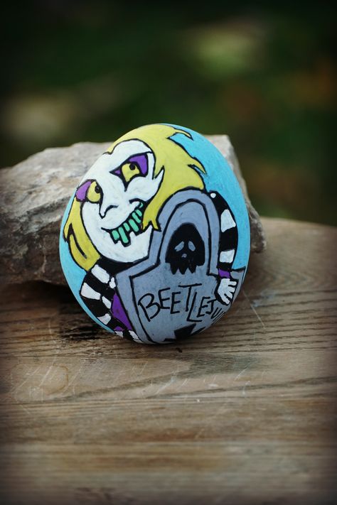 Halloween Painting Beetlejuice, Beetlejuice Art Painting, Beetlejuice Rock Painting, Horror Movie Rock Painting, Beetlejuice Painted Shoes, Beetlejuice Painted Rocks, Halloween Rocks, Halloween Bash, Painted Rocks Craft