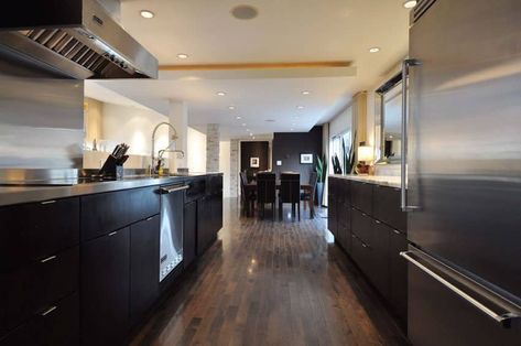 Contemporary dark cabinet galley style kitchen with wood flooring Kitchens 2020 Trends White, Timeless Kitchen Cabinet Colors, Kitchens With Dark Cabinets, Timeless Kitchen Cabinets, Kitchen With Dark Cabinets, Dark Brown Floor, Dark Brown Kitchen, Cabinets Design Ideas, Dacor Appliances