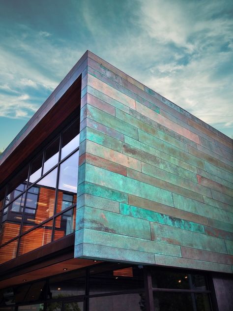 Eagle Harbor Market Building designed by Coates Design Seattle Architects As visitors to Bainbridge disembark from the Bainbridge Island ferry, the Eagle Harbor Market Building welcomes them with inviting plazas, retail shops and restaurants. Its richly-detailed copper patina, beautiful indigenous gardens, and nationally-recognized sustainable features complement the surrounding environment and invite visitors to come shop, eat, and play. Copper In Architecture, Eco Friendly Architecture, Gros Morne, Retail Facade, Commercial And Office Architecture, Metal Facade, House Cladding, Facade Material, Facade Architecture Design