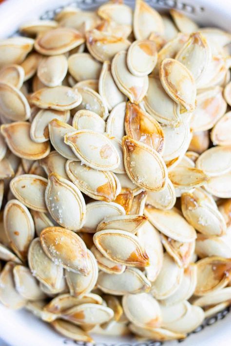 Easily make your own Roasted Pumpkin Seeds to enjoy all throughout Fall! Learn the best way to separate the white seeds from the pumpkin flesh, then season and bake them in the oven to toasted perfection. Snack on these deliciously healthy morsels, or use them as a crunchy addition to soups, salads, and more! How To Roast Pumpkin Seeds In The Oven, Pumpkin Seeds In Oven, Roasting Pumpkin Seeds Oven, Easy Roasted Pumpkin Seeds, Baked Pumpkin Seeds, How To Roast Pumpkin, Roast Pumpkin Seeds, Pumpkin Seeds Baked, Pumpkin Seed Recipes