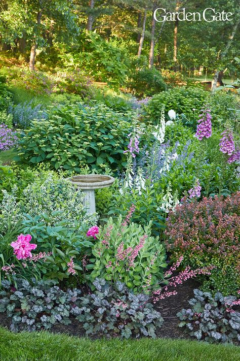 Perennial garden border with foxglove and a stone birdbath Island Garden Bed, Garden Hillside, Yard Remodel, Hill Garden, Bigleaf Hydrangea, Landscaping Around Trees, Hillside Garden, Backyard Garden Layout, Hillside Landscaping