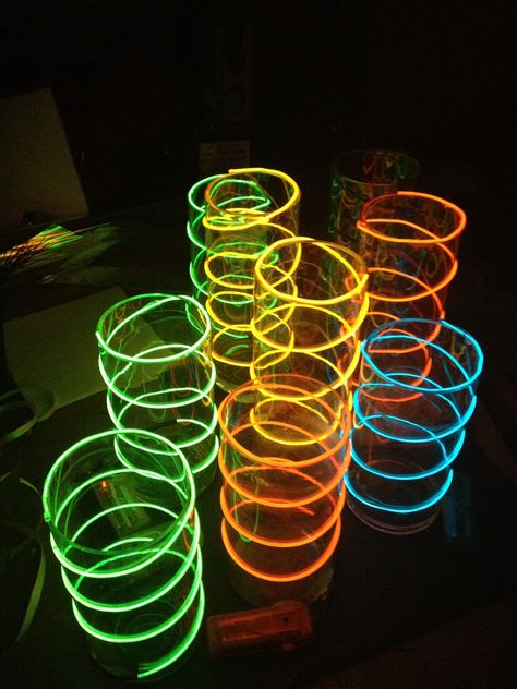 Lighted centerpiece of Glass vases with neon wire inside Neon Flower Centerpieces, Glow In The Dark Table Centerpiece, Neon Party Table Centerpieces, Rainbow Table Centerpieces, Neon Light Table Centerpiece, Glow Party Table Centerpieces, Neon Theme Centerpieces, Neon Glow Centerpieces, 80s Prom Centerpieces