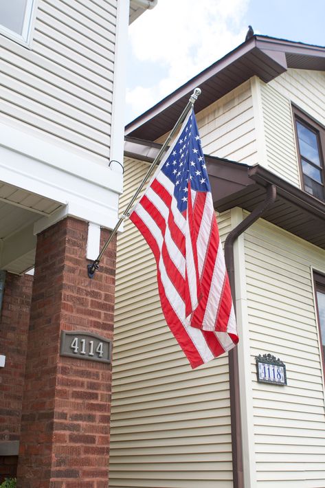 I'm boosting our home's curb appeal through DIY projects. Here's how to install a flag pole into brick in less than 10 minutes. #flagpole Hanging Flags On House Front Porches, Hanging Flag On House, Flag Pole On House, Flag On House, Easy Curb Appeal, Flag Pole Bracket, Window Boxes Diy, Diy Flag, Add Curb Appeal