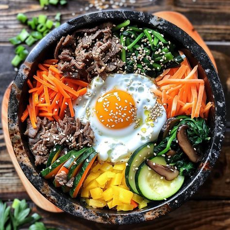 🍚 Enjoy the savory Bulgogi Dolsot Bibimbap! 🍲✨ #Bibimbap #KoreanCuisine Bulgogi Dolsot Bibimbap (Mixed Rice in a Hot Stone Pot) Ingredients: Bulgogi beef, sliced thinly (1/2 lb) Cooked rice (2 cups) Carrots, julienned (1 cup) Zucchini, julienned (1 cup) Spinach, blanched (1 cup) Bean sprouts, blanched (1 cup) Mushrooms, sliced (1 cup) Egg (1) Gochujang (Korean chili paste) (2 tbsp) Soy sauce (2 tbsp) Sesame oil (1 tbsp) Sesame seeds (1 tbsp) Vegetable oil (for cooking) Instructions: Marin... Banchan Korean Side Dishes, Bulgogi Gimbap, Bulgogi Bibimbap, Beef Bibimbap, Korean Meals, Dolsot Bibimbap, Korean Ingredients, Korean Bibimbap, Bibimbap Recipe