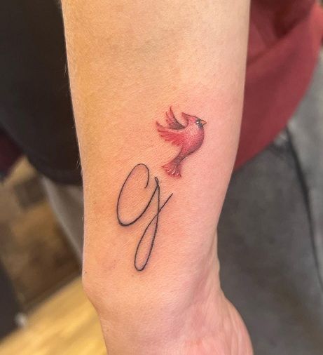 15+ Cardinal Tattoo Designs to Symbolize Love and Hope Small Cardinal Tattoo Wrist, Cardinal Ankle Tattoo, Eagle And Cardinal Tattoo, Cardinal Tattoo Wrist, Tiny Red Cardinal Tattoo, Simple Red Bird Tattoo, Tiny Cardinal Tattoo Memorial, Tattoos Of Cardinals, Little Cardinal Tattoo