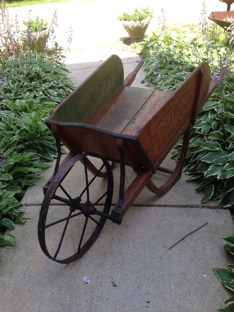 Old wooden wheelbarrow Old Wheelbarrow Ideas, Goat Cart, Wagon Wheel Decor, Wooden Wheelbarrow, Antique Wagon, Wheelbarrow Planter, Wooden Cart, Wheel Barrow, Wooden Wagon