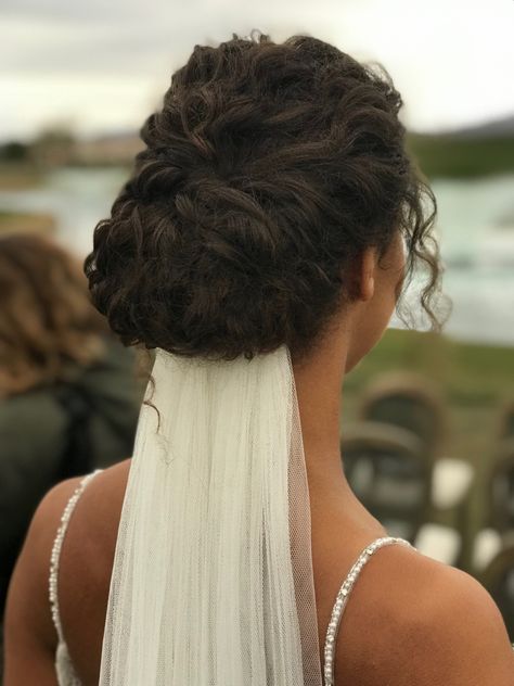 Curly Hair Bun Wedding Hairstyles, Brides With Curly Hair, Low Bun Wedding Hair Curly, Curly Updo With Veil, Curly Bridal Hair With Veil, Curly Wedding Hair With Veil, Curly Hair Wedding Updo, Bride Hairstyles Curly Hair, Curly Updo Wedding