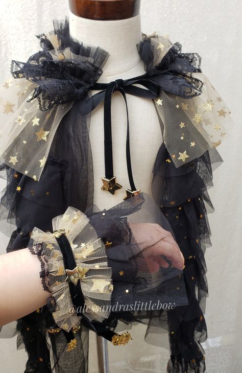 Celestial arm cuffs tie with a ribbon into a bow. *cuffs only, cape sold separately Celestial Clothes Men, Bow Tie Reference, Space Theme Clothes, Celestial Cosplay, Celestial Outfit Male, Celestial Witch Costume, Celestial Aesthetic Clothes, Celestial Accessories, Star Themed Outfits