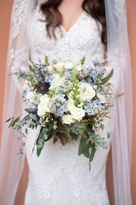 Pale blue and white winter wedding bouquet Blue Winter Flowers, January Wedding Flowers In Season, Winter Wedding Bouquet Blue, Delphinium Wedding Bouquet, Winter Flowers Wedding, Winter Flower Bouquet, January Wedding Flowers, Winter Wedding Flowers Bouquets, Viburnum Berries