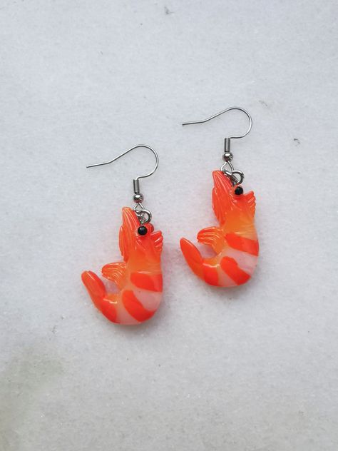 Shrimp earrings. Funny, unique shrimp jewelry. You don't need to go to the fish store or restaurant to taste these chic shrimps earrings. Bo bold and surprise everyone. W E L C O M E Welcome to Piranha Unique Jewelry! Thank you for visiting our shop. We are glad you found your way here. If you have any questions, please do not hesitate to contact us! We're more than happy to help. P R O D U C T ∙ I N F O Ear wires (standard): Hypoallergenic Surgical Stainless Steel Ear wires (option): High Quali Shrimp Jewelry, Reef Animals, Coral Reef Animals, Shrimp Earrings, Ocean Coral Reef, Fun Restaurant, Animals Jewelry, Seafood Sushi, Fish Store