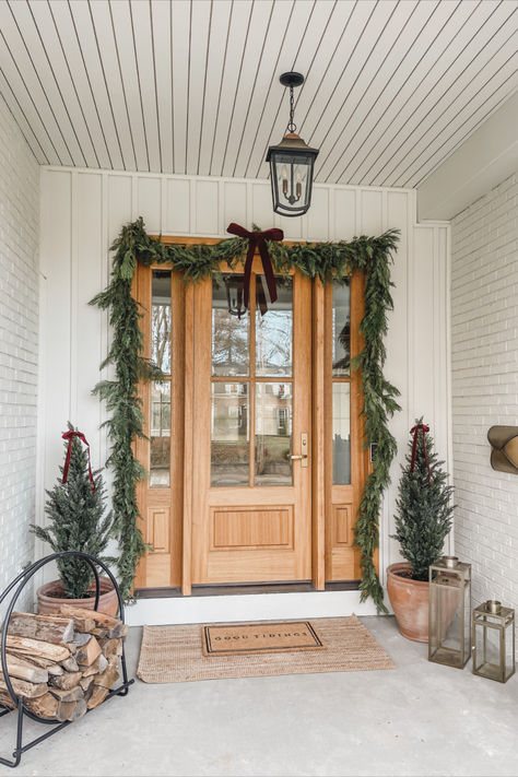 Front door views, holiday home, seasonal finds, front door refresh, faux garland, faux tree, velvet ribbon, neutral home, aesthetic home, doormat finds, Christmas entry, Amazon, Target, William-Sonoma, holiday finds, creamy whites, warm woods, neutral Christmas vibes, warm and cozy, Target Christmas style, Amazon Christmas, holiday front entry look, lighting detail, red velvet detail, light and bright, neutral front entry, cozy winter vibes White House With Christmas Wreaths, Christmas Porch Double Doors, White House Christmas Decorations Exterior, Garage Door Wreath, Exterior Wreaths Christmas, Christmas Wreaths For Double Front Door, Christmas Lights On House Exterior Farmhouse, Christmas Double Door Decor, Wreaths Outside Windows