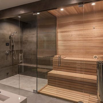 Lap Pool Designs, Modern Saunas, Sauna Shower, Beige Cabinets, Light Wood Cabinets, Modern Bathroom Remodel, Sauna Design, Grey Countertops, Bathroom Tile Designs