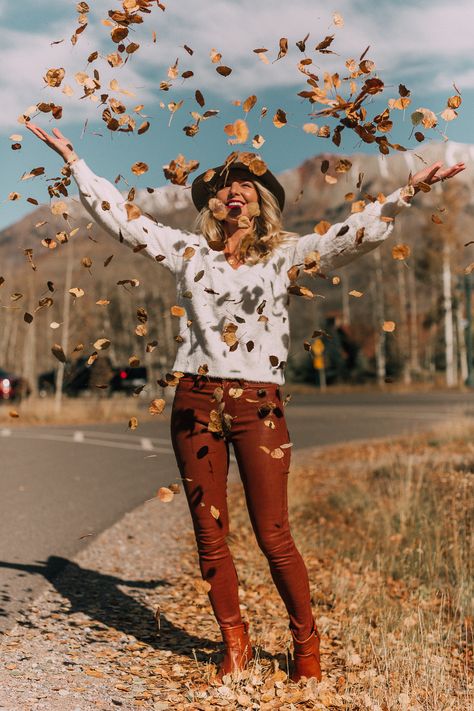 Blonde woman in Telluride, Colorado wearing brown leather pants by Frame with a white fuzzy Halogen sweater, Saint Laurent boots, and a rag & bone hat, throwing leaves in the air Autumn Aesthetic Tumblr, Autumn Photography Portrait, Portret Feminin, Fall Shoot, Fall Portraits, Shotting Photo, Photographie Portrait Inspiration, Fall Photoshoot, Trik Fotografi