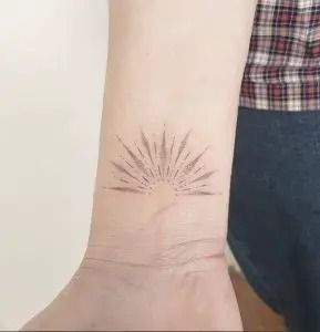 Sunburst Tattoo: Meaning, Placement & Design Ideas - Tattoo Twist Sunburst Tattoo, Mandala Sun Tattoo, Dotwork Tattoo Mandala, Simple Line Tattoo, Ray Tattoo, Egyptian Tattoo Sleeve, Chic Tattoo, Light Tattoo, Dot Tattoos