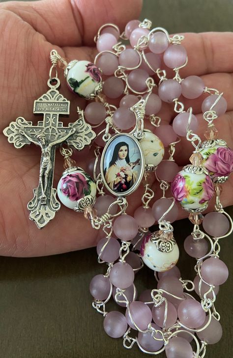 "This beautiful handmade rosary is made with 8mm cat's eye matte pink glass, 10mm ceramic beads and 2\" Pardon crucifix.   Length: 20\" inches long" Cute Rosary, Beautiful Rosary, The Rosary, Mary Aesthetic, Rosary Art, Rosary Aesthetic, Rosary Coquette, Handmade Pink Rosary With Cross, Pink Beaded Spiritual Rosary