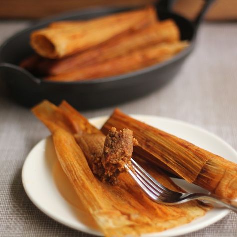 New Orleans-Style Hot Tamales | Emerils.com -- A spicy, chile-laden filling is rolled in corn husks and then steamed in a flavorful broth. These tamales do take some time, but invite friends over and make it a communal effort or do it in stages, time permitting. The filling can be made one day, then refrigerated for up to several days before rolling and steaming the tamales. Once cooked, the tamales hold well in the refrigerator up to several days, can also be frozen and microwaved to reheat. Hot Tamales Recipe Southern, Relleno Recipes, Hot Tamales Recipe, Cajun Meals, Homemade Tamales Recipe, Soul Recipes, Louisiana Cooking, Mexican Tamales, Latin Dishes