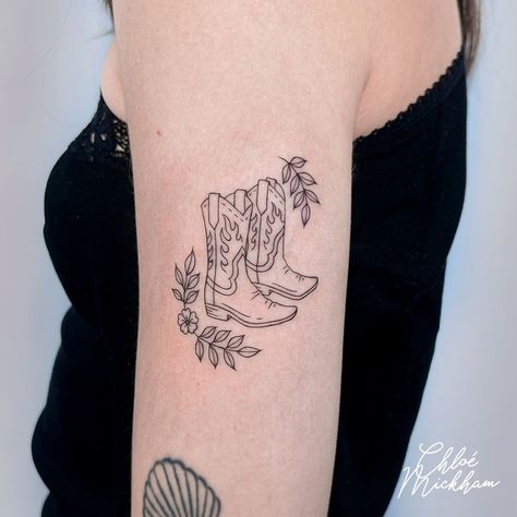 Cowboy Boots Fine Line Tattoo • Tattoo uploaded by Chloe Mickham Flower Cowboy Boots Tattoo, Boot Tattoos For Women, Cowboy Boots Tattoo For Women, Cowboy Boot With Flowers Tattoo, Cowboy Tattoo For Women, Lasso Tattoo, Cowboy Like Me Tattoo, Cowgirl Hat Tattoo, Cowgirl Boot Tattoo