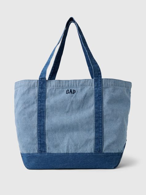 Soft cotton denim tote bag.  Shoulder straps at top.  Inner pocket with zipper.  Embroidered mini Gap arch logo at front.  Responsibly Made: This denim bag s is part of our water-saving Washwell program.  Compared with conventional wash methods, Washwell uses at least 20% less water and has saved over a billion liters of water since 2016.  This product was made in a factory that invests in gender equality and women’s empowerment.  Through RISE Reimagining Industry to Support Equality) and Gap In Tote Bag With Pins, Tote Bags With Zipper, Tote Bag Outfit, Trendy Bags, Gap Logo, Arch Logo, Jean Crafts, Denim Tote Bags, Denim Tote