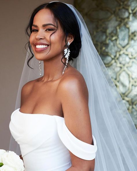 Sabrina Dhowre Elba's wedding hairstyle is the perfect mix of polished and undone. The model pulled her tresses back into a curled chignon, but she added details to make the hairdo feel more fresh. For example, she parted her hair down the center and pulled two pieces out in front. For a unique twist, she rocked a veil on one side of her head. From minimalist up-dos to glamorous waves, we have hair inspo ahead for every kind of to-be-wed. See our favorite celebrity wedding hairstyles, here. Wedding Hair 4c, Natural Curly Hair Wedding Styles With Veil, Low Bun Wedding Hair Black Women, Black Wedding Hairstyles For Bride, Natural Wedding Hairstyles Black Bride, Bridal Hair Black Women, Black Bridal Hairstyles, Celebrity Wedding Hairstyles, Black Women Wedding Hairstyles