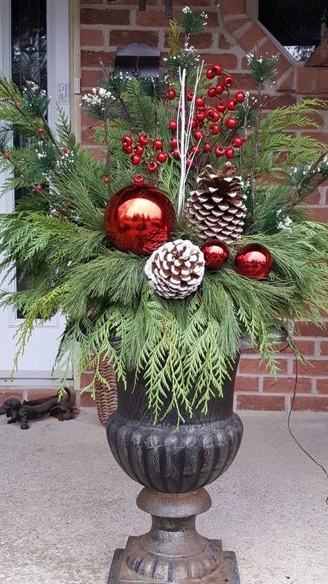 90+ Easy DIY Outdoor Christmas Decorations - Holidappy Front Door Christmas Planters, Urn Planters Front Door Christmas, Large Ornaments Outside, Christmas Pots Outside Front Porches, Christmas Urns Front Porch, Easy Diy Outdoor Christmas Decorations, Easy Outdoor Christmas Decorations, Outdoor Holiday Planters, Diy Outdoor Christmas Decorations