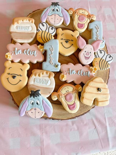 Amelia’s Winnie The Pooh 1st Birthday Party - Teacher Turned SAHM Winnie The Pooh Three Birthday, Pooh Bear Themed First Birthday, Birthday Idea 1 Year, Winnie The Pooh Biscuits, Pooh Decorations Party, Baby’s 1st Birthday Party Themes, First Birthday Pooh Bear, Winnie The Pooh First Birthday Cookies, Our Little Hunny Turns One