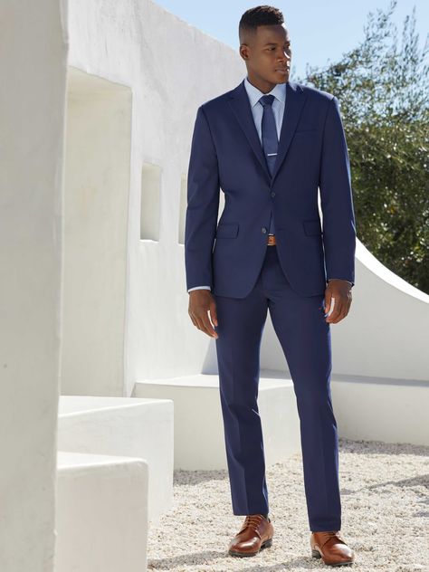 This slim fit suit jacket from Perry Ellis is a stylish and versatile option for any occasion. The dobby fabrication is characterized by miniature geometric patterns woven into the fabric, giving it a unique and eye-catching look. The 4-way stretch provides added flexibility and comfort, while the wrinkle-resistant finish ensures that you'll look your best all day long. 65% Polyester / 28% Viscose / 7% Elastane Slim Fit Dobby Fabrication Is Characterized By Miniature Geometric Patterns Woven Int Navy Blue Suit With Blue Shirt, Navy Suit Men's Outfit, Wedding Men Suit Blue, Formal Wedding Suits Men, Male Wedding Guest Outfit Formal, Navy Men’s Suit Wedding, Formal Wedding Outfit Men, Men’s Wedding Guest Attire Spring Formal, Blue Suit Wedding Guest