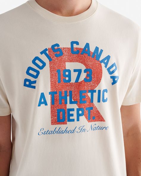 Our Mens Roots Athletic Dept. T-shirt is made for effortless, everyday wear. Crafted in comfy organic cotton jersey, it also features a cool printed graphic. 100% organic cotton jersey Classic fit Ribbed neck Front chest graphics Heritage clip label ABOUT 100% cotton jersey SIZE & FIT The model is wearing a size medium Model Measurements: Height: 6'1 Chest: 39 Waist: 32 ; suit size: 40-R; neck: 15.5 ; sleeve: 34.5 CLASSIC FIT Our Classic Fit is made for comfort. Not too close to the body, but not too loose. LOOK AFTER ME Reverse garment before washing or ironing Machine wash cold, gentle cycle with like colours No bleach Tumble dry low - low iron Do not iron decoration Do not dry clean | Roots Men's Athletic Dept. T-Shirt in Snowdrift White Athletic Dept Shirts, Graffiti Tshirt, Sweat Sets, Ironing Machine, Merch Design, Newborn Accessories, Kids School Backpack, Leather Factory, Sweat Dress