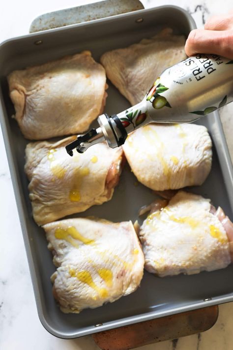 The flavor of these perfectly roasted chicken thighs is incredible. This easy 5-ingredient oven-baked bone-in chicken thigh recipe is the perfect staple recipe and easy weeknight dinner. These low-carb chicken thighs are super-juicy with the crispy skin you want. Use this recipe for meal prep and batch cooking too. | Real Simple Good Skin On Chicken Thigh Recipes Oven Baked, Quick Bone In Chicken Thigh Recipes, Chicken Thigh Marinade For Oven, Skinned Chicken Thigh Recipes, Baked Chicken Thigh Recipes Bone In, Recipes For Bone In Skin On Chicken Thighs, Chicken Thighs With Bone And Skin, Cast Iron Chicken Thigh Recipes, Bone In Chicken Thigh And Leg Recipes