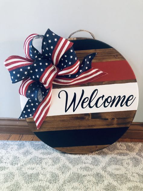 Round Signs Diy, Cricut Door Decorations, American Door Hanger, Red White Blue Door Hanger, Red White And Blue Wood Crafts, America Door Hanger, Fourth Of July Wood Signs, 4th Of July Round Wood Signs, Patriotic Door Sign