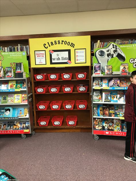 Classroom Wish List set up for book fair. Utilized the book shelves to set up this display and placed the carts on both sides. It was a huge success with the teachers and majority of the books were purchased. Book Fair Wish List Display, Scholastic Book Fair Set Up, Book Fair Raffle Ideas, Scholastic Book Fair Teacher Wish List, Book Fair Display Ideas, Book Fair Set Up, Book Fair Table Display, Book Fair Teacher Wish List Display, Scholastic Book Fair Ideas