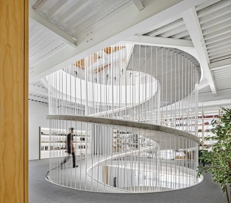 Constructed with formwork on-site, the 4-inch-thick ramp is shaped like an orange peel. In northern Portugal, a sculptural ramp joins two buildings—and two companies—into a cohesive, flexible, future-proof whole by Paulo Merlini Architects. #interiordesign #architecture Spiral Architecture, Ramps Architecture, Ramp Design, Concrete Walkway, Studios Architecture, Spiral Stairs, Ground Floor Plan, Architecture Office, Spiral Staircase