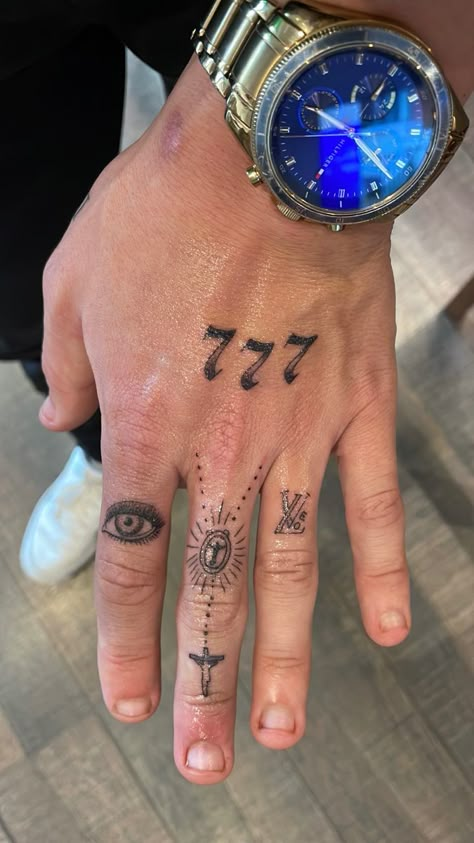 Hand tattoo for men, angel numbers, eye, cross, religious, love, LV Guys With Hand Tattoos, Men Angel Number Tattoo, Angel Numbers Tattoo Men, Fine Line Hand Tattoo Men, Lv Hand Tattoo, Religious Hand Tattoo, Finger Tattoos For Men Letters, Angel Hand Tattoo Men, Angel Number Tattoo Men