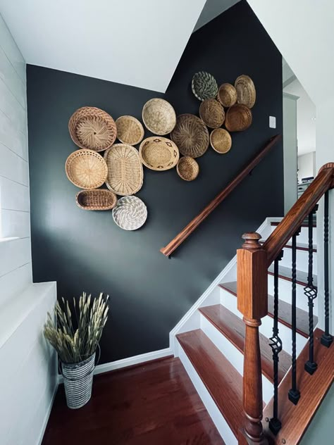 Big Wall Basket Decor, Baskets On Black Wall, Basket Wall Up The Stairs, Wicker Basket Wall Art Bedroom, Basket Wall Layout, Wicker Basket Wall Art Living Room, Black Walls Staircase, Black Wicker Basket, Black Fox Paint Color