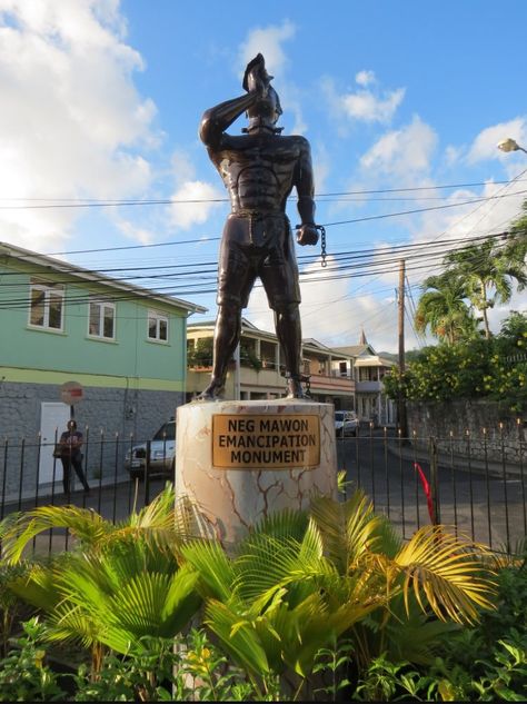 Read the Plaque - Neg Mawon Emancipation Monument THIS MONUMENT IS A SYMBOL OF FREEDOM AND EMANCIPATION. IT IS A TRIBUTE TO ALL THE ENSLAVED AFRICANS WHO SUFFERED AND WERE EXECUTED IN THE HISTORY OF DOMINICA.  IT HONOURS THE MAROONS WHO RISKED THEIR LIVES TO FIGHT FOR THE EMANCIPATION OF ALL. IT PAYS HOMAGE TO THOSE WHO WERE SOLD AND EXECUTED AT THE OLD ROSEAU MARKET AND WHO WERE HELD AT THE BARRACOON BUILDING IN ROSEAU BEFORE BEING SOLD AND SENT TO THE PLANTATIONS.  THIS MONUMENT SALUTES THE ME Neg Mawon, Haitian Architecture, Haitian Revolution History, African Ancestors, Haitian Landscape, Trinidad And Tobago Architecture, Gabon Flag, Haitian Culture, Symbol Of Freedom