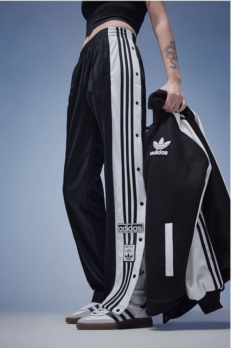 Make Your Daily Style Stand Out With These Women's Adibreak Track Pants From Adidas Originals. In A Black Colourway, These Mid-Rise Pants Are Made From Smooth Recycled Polyknit Fabric To Keep Them Lightweight. They Feature An Elasticated Waistband With A Drawcord Tie, While The Snap-Button Legs Offer A Verstaile Fit. With Secure Side Pockets For Your Essentials, These Pants Are Finished Off With The 3-Stripes And Retro Adidas Trefoil Branding. Machine Washable. | Our Model Is 5'6" Adidas Side Button Pants Outfit, Sports Wear Womens Casual, Adibreak Pants Outfit Women, Y 3 Adidas, Pants With Buttons On Side, Adidas Clothes Women, Adidas Jogger Outfit, Adidas Pants Outfit Fashion, Adidas Track Pants Outfit Woman