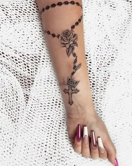 70 Cross Tattoos For Women That Are Easy To Bare Rosary Rose Tattoo, Rosary Tattoo Forearm Women, Crucifix Tattoo For Women, Rosary Tattoo Wrist Woman Crosses, Rosary Cross Tattoo, Tattoos For Women Cross, Rosary Tattoo For Women Arm, Rosary Tattoo Design, Rosary Tattoo Arm