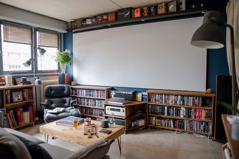 A Cinephile's Parisian Rental | Apartment Therapy Projector Small Living Room, Tiny Theater Room Ideas, Living Room Projector Screen, Apartment Projector Setup, Projector Setup Ideas Living Room, Projector Apartment, Projector Screen Basement, Living Room Projector Wall, Projector Wall Ideas