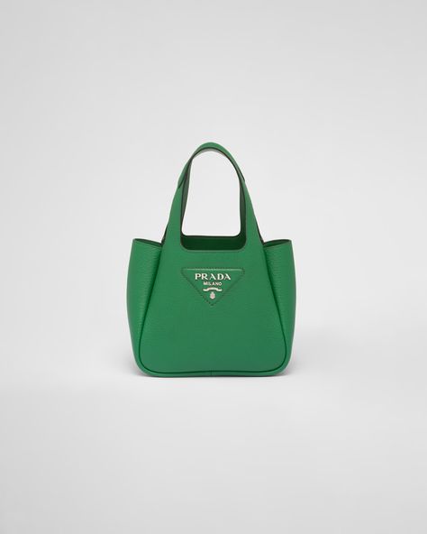 Reverse stitching emphasizes the soft roundness of the silhouette of this handbag. The accessory is decorated with a new interpretation of the triangle created with stitching, with the Prada metal lettering logo gleaming at its center. Prada Mini Bag, Green Leather Handbag, Prada Mini, Metal Lettering, Leather Mini Bag, Green Tote, Lettering Logo, Prada Leather, Mini Pouches