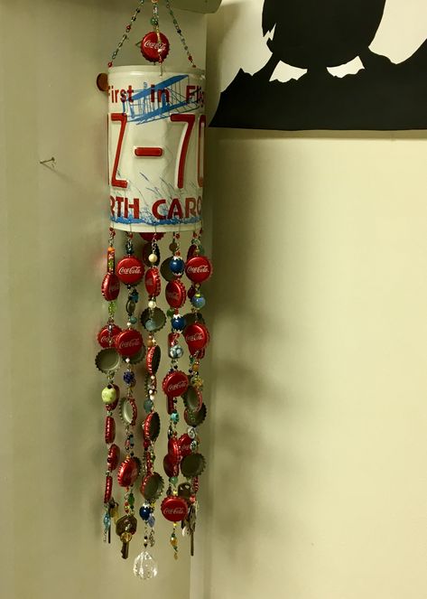 Recycled Object Wind-chime made with license plate, old keys, broken jewelry, coca-cola bottle caps, buttons, obsolete electronic resisters Plastic Bottle Cap Wind Chime, License Plate Wind Chime, Cherry Coke Bottle Cap, Coke Bottle Bird Feeder, Beer Bottle Cap Art Red Truck, Wind Chain, Old Keys, Coca Cola Bottle, Plate Art