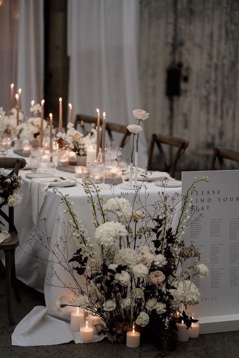 Neutral minimalistic table plan and wedding tablescape with long tapered beige candles, light grey ceramic plates and candle holders, neutral floral decorations and pillar candles Sam Sparks, Beige Candles, Taper Candles Wedding, Welsh Wedding, Pillar Candles Wedding, Ceiling Drapes, Wedding Top Table, Long Table Wedding, Wedding Candles Table