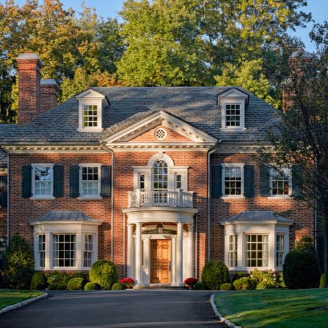 This new 7,000 square foot brick home was built for a growing young family as a long-term family homestead. The Georgian revival style was chosen to help the house fit seamlessly into the neighborhood, a region already marked by its early 20th century Georgian and Tudor Revival homes.

#redbrickhouse #slateroof #modillions #dormers #palladianwindow #doriccolumns #windowbay #frontportico #curvedporch #georgianstyle #traditionalarchitecture #classicaldesign #khakumwood #GreenwichCT House With Lots Of Windows, Georgian Revival Homes, Georgian Style Homes, Black Shutters, Dream Things, Georgian Architecture, Lots Of Windows, Red Brick House, Brick Exterior House