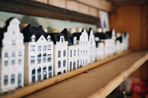 6 Ways to Style KLM Delft Blue Houses Throughout Your Home — The Property Lovers Blue Houses, China House, Dramatic Background, House App, Antique Hutch, Dutch House, Blue White Decor, Canal House, Christmas Interiors