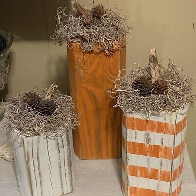 Farmhouse\Rustic Wood Pumpkin Fall Decor. Set of 3. These pumpkins measure 4 in wide and 3 in thick. The orange pumpkin is 10 in tall, the striped pumpkin is 8 in tall, and the white pumpkin is 6 in tall. They are made with treated wood and the paint ta are indoor/outdoor. They have a distressed finish with Spanish moss and mini pine cone accents around the wood stem. They would make a beautiful addition to any indoor or porch decor. Wooden Pumpkin Porch Decor, Fall Crafts For Adults Diy, Crafts For Adults Diy Projects, Scrapbook Cards Ideas, Wooden Halloween Decorations, Primitive Fall Crafts, Block Pumpkins, 2x4 Crafts, Fall Crafts For Adults