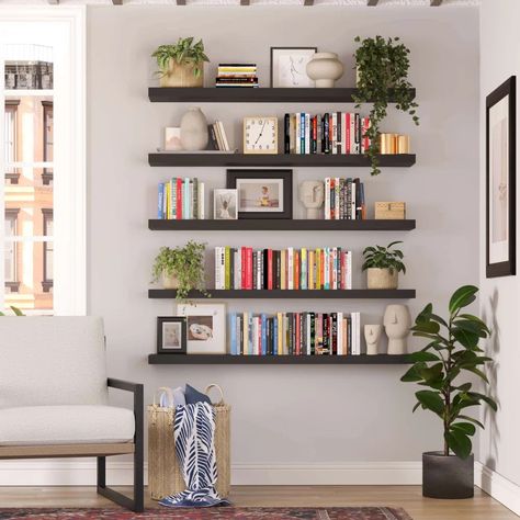 Ebern Designs Meekal Engineered Wood Floating Shelf | Wayfair Wall Mount Book Shelf Ideas, Black Shelves Decor Living Room, Floating Shelves With Books And Plants, Floating Shelves Books And Plants, Black Floating Bookshelves, Wall Book Shelves Living Room, Floating Shelves Large Wall, Floating Shelf Bookcase, Neat Bookshelves