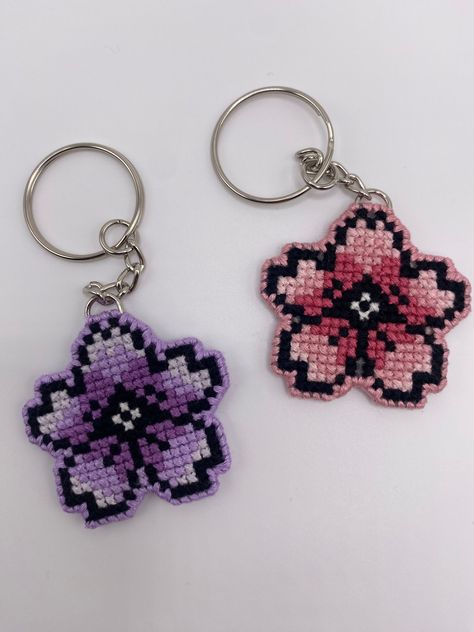 This is a handmade double sided cross stitched key chain. The cherry blossom contains a gradient in the color selected. If you would like a custom color, please feel free to message me!  Please feel free to reach out to me if you have any questions or if there is a problem with your order! Cross Stitch Keyring Patterns, Keychain Cross Stitch, Cross Stitch Keyring, Hello Kitty Cross Stitch Patterns, Sakura Cross Stitch, Cherry Blossom Cross Stitch, Hello Kitty Cross Stitch, Cross Stitch Keychain, Mini Cross Stitch Patterns