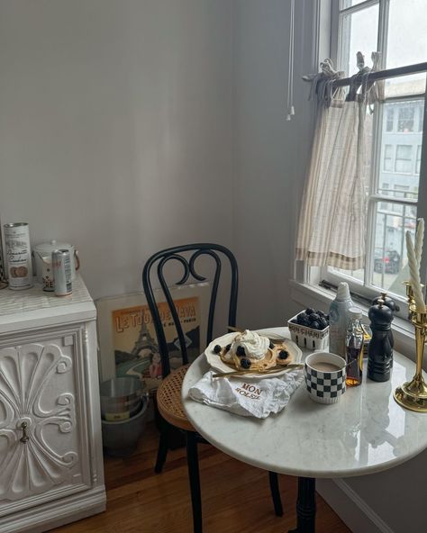 Bistro tables are the perfect way to maximize space in a small kitchen, as well as injecting Parisian flair 🥐🥞 The added cafe-curtain, napkins, and French art piece are only adding to the Eurosummer vibes. Bravo @citychateau! #eurosummer #bistrotable #parisianstyle #smallkitchen #interiorstyling #myrealhome Kitchen Parisian Style, Kitchen Bistro Table, Small Kitchen Ideas Table, Cafe Style Kitchen, Small French Apartment, Bistro Aesthetic, Bistro Table Indoor, French Bistro Decor, Parisian Style Kitchen