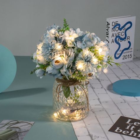 PRICES MAY VARY. PACKAGE - Including LED lights, 3 aritficial Blue Rose Bouquets and a Glass Vase. Total height is about 13”/33CM. Vase height is 6.3"/16CM. Flower height is about 13”/33CM. CREATIVE LED DECORATION - This Table LED flowers is perfect for your wedding, party, baby shower or home decor, etc. EASY TO SET UP- Put half of the led lights in the vase, and wrap the rest around the fake flowers. The LED lights have 8 remote control mode. LIGHT UP YOUR LIFE - The entire flowers and vase ar Centerpieces Quinceanera, Mesas Para Baby Shower, Blue Wedding Centerpieces, Blue Wedding Decorations, Blue Party Decorations, Centerpiece Home, Blue Centerpieces, Lighted Centerpieces, Jar Centerpieces