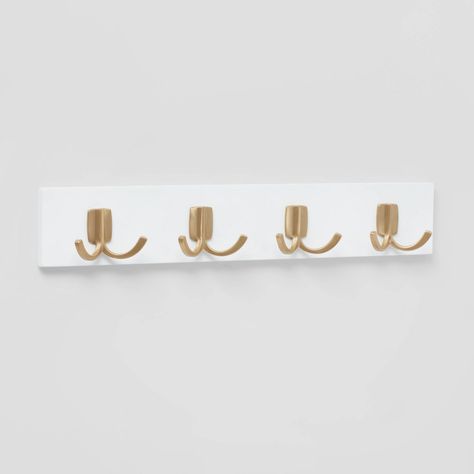 Create additional storage in your home with this Modern Octopus 4-Hook Rail with Gold Hooks from Brightroom™. This decorative hook rail with a clean modern design showcases a flat white base that has four gold-finish dual hook points for hanging hats, coats, jackets, belts or other items. Just wall mount it in your laundry room, bathroom, entryway or kitchen to maximize storage space. Brightroom™: See your space in a new light. Cute Coat Hooks, Light Pink And Gold Room Ideas, Cute Hooks For Wall, Bag Hooks Wall, Gold Hooks Entryway, Gold Wall Hooks, Cute Wall Hooks, White And Gold Room Decor, Dorm Room Bathroom Ideas